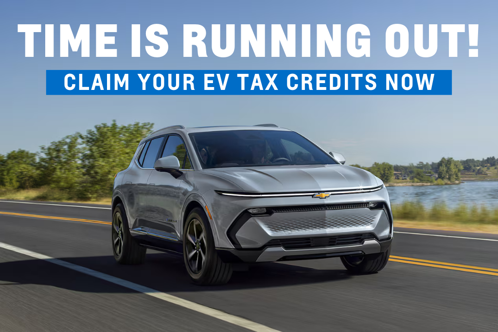 Silver Chevrolet electric SUV driving on a scenic road near water, with text reading “Time is running out! Claim your EV tax credits now,” promoting Platinum Chevrolet in Santa Rosa.