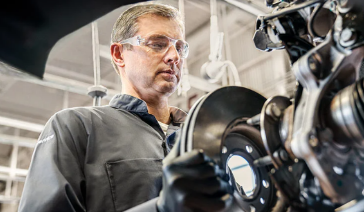 Platinum Chevrolet technician inspecting a vehicle’s brake system in the Santa Rosa service center.