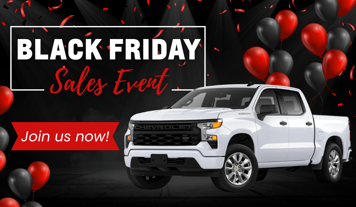 White 2025 Chevrolet Silverado truck showcased with red and black balloons and spotlights during Platinum Chevrolet’s Black Friday Sales Event in Santa Rosa.